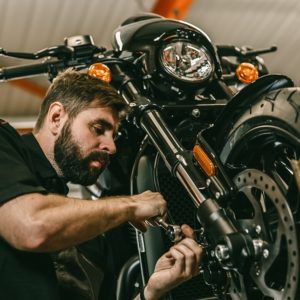 Professional motorbike mechanic working on a motorcycle, representing the skills taught in the Motorbike Mechanic Course by iStudy.