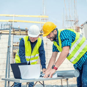 Construction managers reviewing plans on-site, representing the skills taught in the Construction Management Diploma Level 5 course.